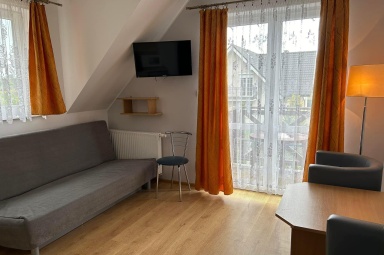 Apartament numer 5 - salon z aneksem kuchennym i wyjście na balkon 